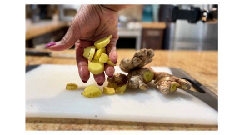 Hands holding fresh sliced ginger root, showing its natural texture and golden color.