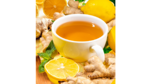 Glass of fresh lemon ginger drink with sliced lemon and ginger root, served in a clear glass on a bright, natural background.